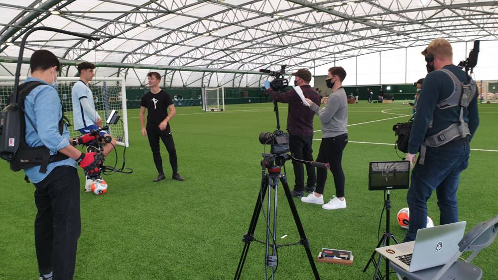 Filming a Chelsea player with a presenter on the indoor training pitch