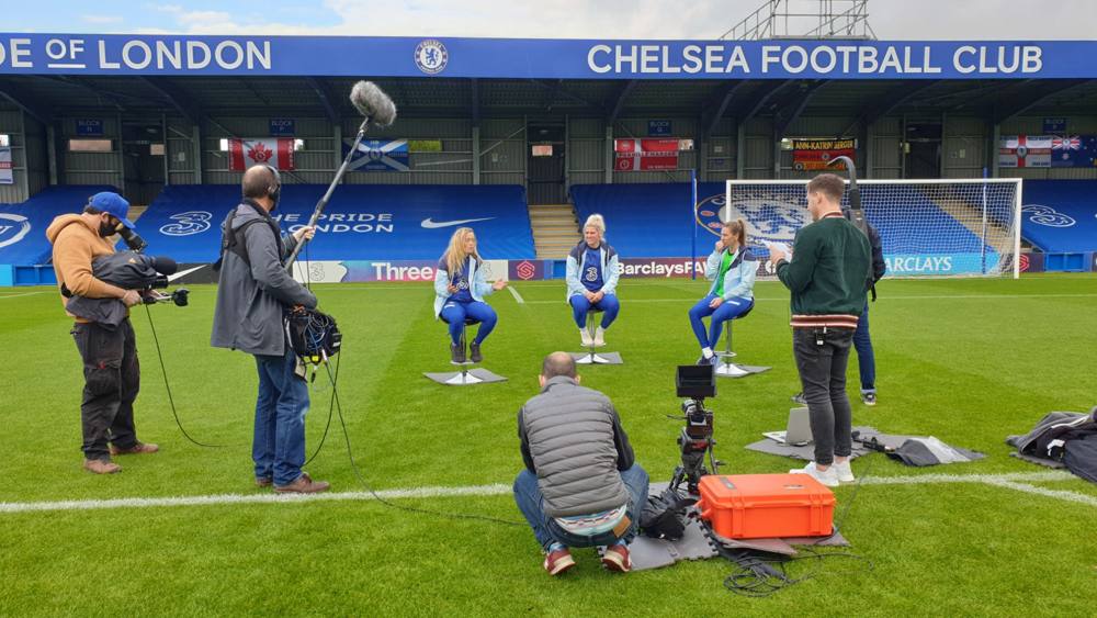 Filming three Chelsea women's players on stools on the pitch