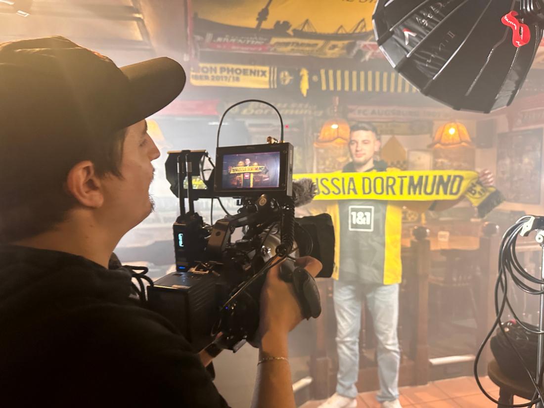 Filming a fan holding a Borussia Dortmund scarf in a pub