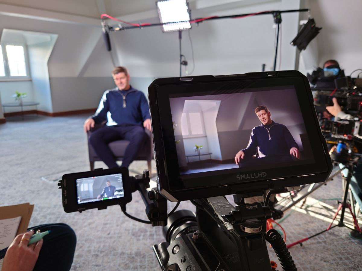Monitor view of Steven Gerrard mid-answer